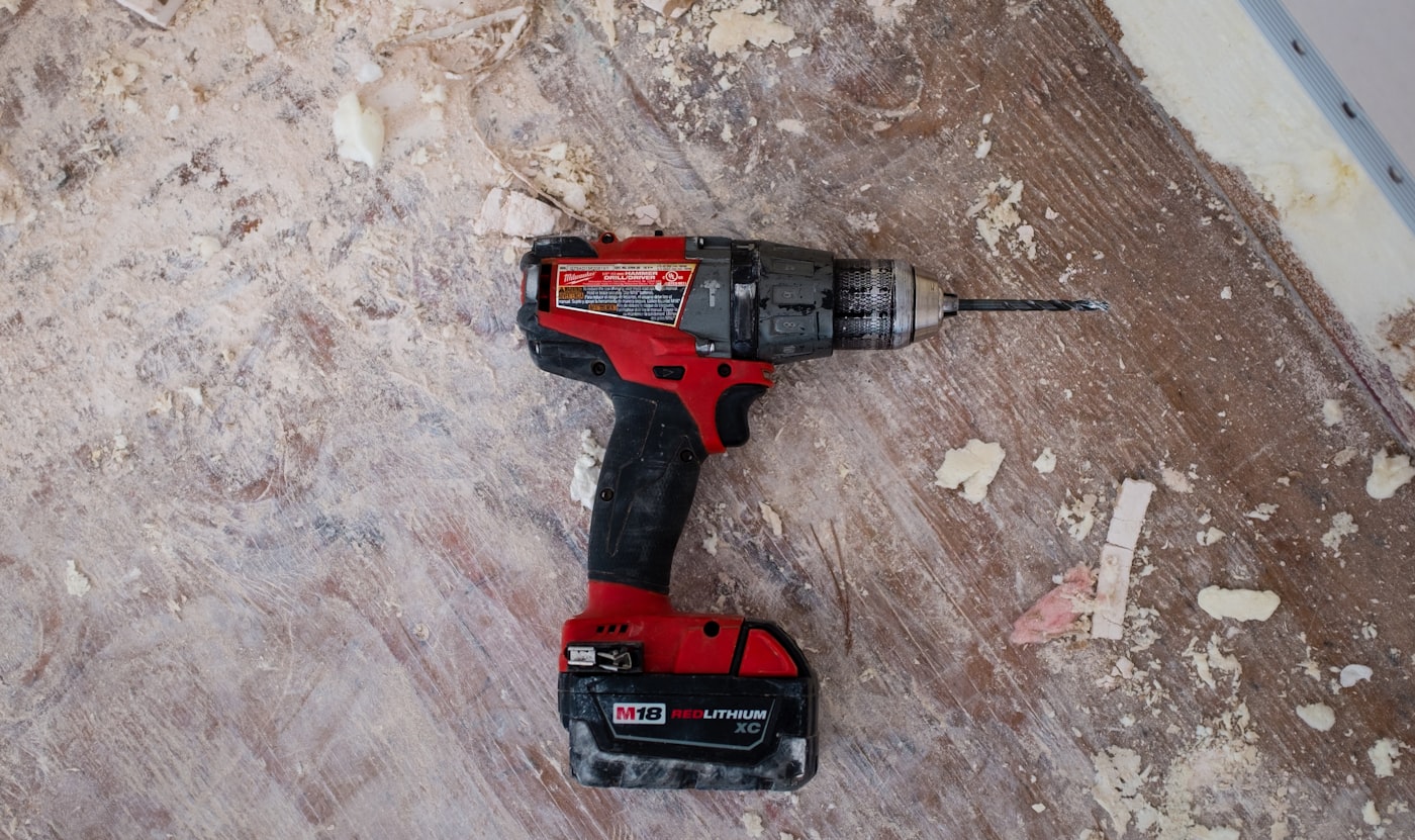 Hand tools laid out on a worn workshop bench